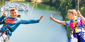 Things to do in Looe - Two Children high in the sky on the zip-wire ride